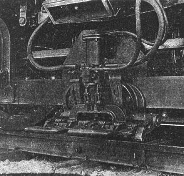 The Collector Shoes for Taking Current from the Third Rail. When Not in Use the Shoe is Drawn Up Clear of the Rail by the Compressed-Air Cylinder Shown Above the Shoes.