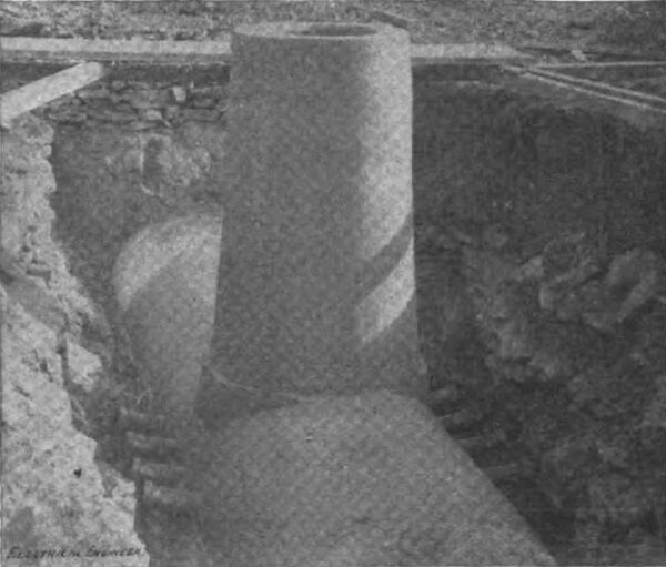 CONDUIT FOR ELECTRICAL CONDUCTORS SHOWING MANHOLE AND BRANCH OUTLETS.