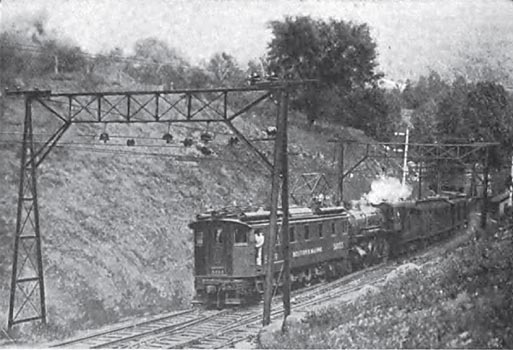 FIG. 3�ELECTRIC LOCOMOTIVE DRAWING STEAM LOCOMOTIVE AND TRAIN OUT OF TUNNEL