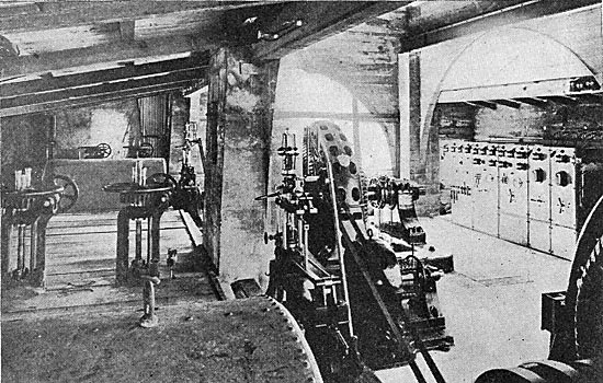 FIG. 4.�VIEW IN POWER HOUSE, SHOWING  WATER WHEEL HOUSINGS, GENERATORS AND SWITCHBOARD.