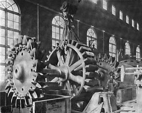PLACING THE WATER WHEELS AND ROTOR SHAFT OF A SINGLE UNIT IN ITS BEARINGS.