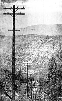 FIGURE 14 � A PORTION OF THE MOUNTAIN POLE LINE, WITH THE POWER HOUSE SITE, PIPE LINE AND RESERVOIR MOUNTAIN IN THE BACKGROUND.