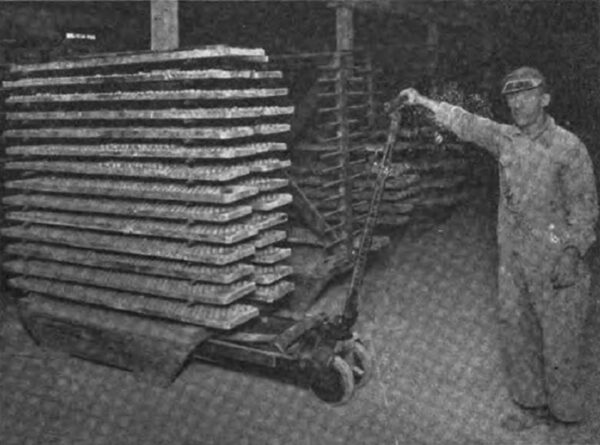 Fig. 2. The Truck is Pushed Under the Load and the Load Raised by Bearing Down on the Truck Handle.