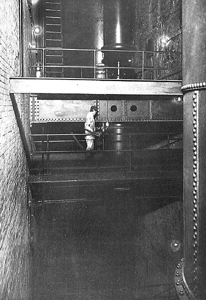 IN THE WHEEL PIT. OBSERVING THE TEMPERATURE OF A GUIDE BEARING ON ONE OF THE MAIN SHAFTS