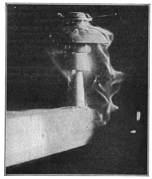 NO. 307 INSULATOR ON METAL PIN AND CROSS-ARM, ARCING TO CROSS-ARM AT 40,000 VOLTS, UNDER RAIN TEST. PRECIPITATION 3-4 INCHES PER MINUTE