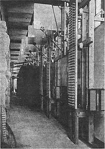 Fig. 3. Room for Step-Up Transformers: Lightning Arresters, High-Tension Switches, Etc., in Foreground.