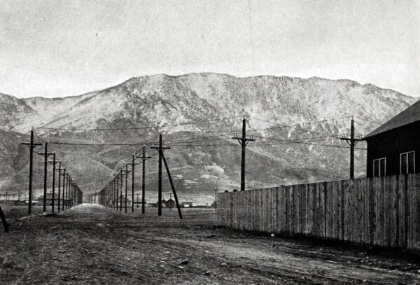 THE 57,000-VOLT DOUBLE TRANSMISSION LINE OF THE MISSOURI RIVER POWER COMPANY NEAR THE BUTTE SUBSTATION. IN THE BACKGROUND THE MAIN RANGE OF THE ROCKY MOUNTAINS CAN BE SEEN, CONSTITUTING THE CONTINENTAL DIVIDE. THE LINES ARE MADE UP OF SIX COPPER WIRES.