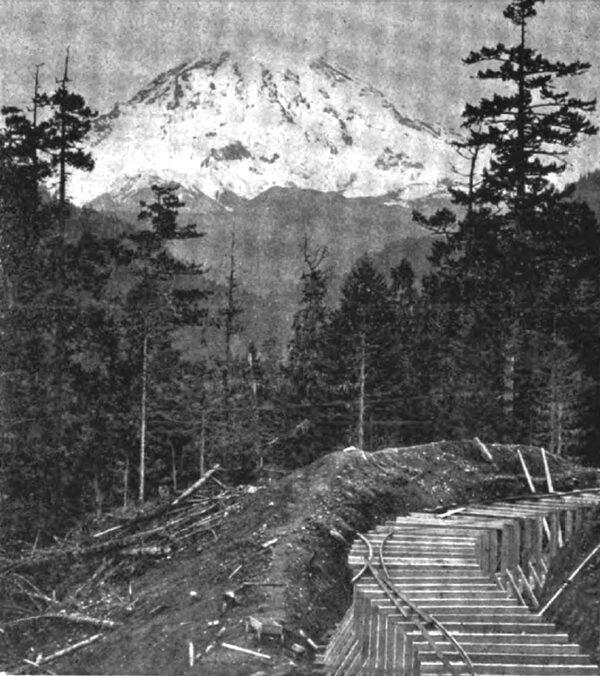 FIG. 11. � PARTIALLY CONSTRUCTED FLUME LINE SHOWING MT. RAINIER IN THE DISTANCE.
