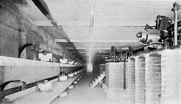 FIG. 12. � VIEW OF THIRD FLOOR SWITCHHOUSE, SHOWING AT LEFT ONE SET 2,300-VOLT BUS BARS WITH CONCRETE BARRIERS, AND AT RIGHT REMOTE-CONTROL GENERATOR AND TRANSFORMER 2,300-VOLT OIL SWITCHES.