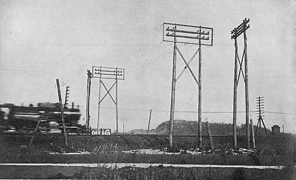 FIG. 5. � SHOWING WIRE CAGE GUARD ON THE SIDES OF AND BENEATH THE 13,000-VOLT TRANSMISSION LINES AT A PENNSYLVANIA RAILROAD CROSSING.