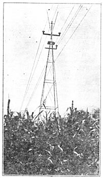 FIG. 2 � Showing first change.  Top insulator lowered, grounded cable in place, and lightning-rods left in position.