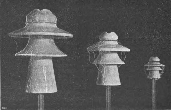 Fig. 17. Support insulators of different sizes under voltage to illustrate the different types of discharge