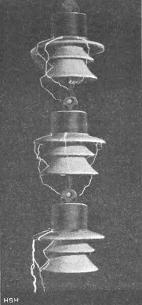 Fig. 22. Spark discharges on three series-connected suspension insulators at 165,000 V.