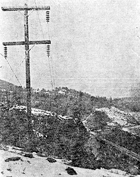 MILWAUKEE RAILWAY 100,000 VOLT TRANSMISSION LINE. DOUBLE ARM CONSTRUCTION AT HIGH POINT.  NOTE STRANDED STEEL GROUND WIRE ON END OF CROSS ARM