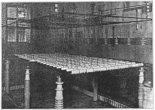 High-Voltage Bushings Mounted on Racks for Indoor Testing.