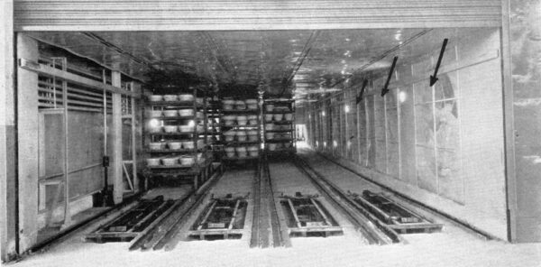 Fine View of the Inside of the Truck Type Mold Release Dryer. The Fans, Enclosed by Screens, Are Lined Up Along the Entire Right Hand Side of the Dryer. The Fans Are Indicated by Arrows.