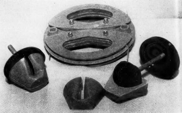 Fig. 1 (Foreground). The suspension insulator for crossarms and single circuit assemblies, shown assembled (left) and disassembled (right). (Top) The transposing plate.