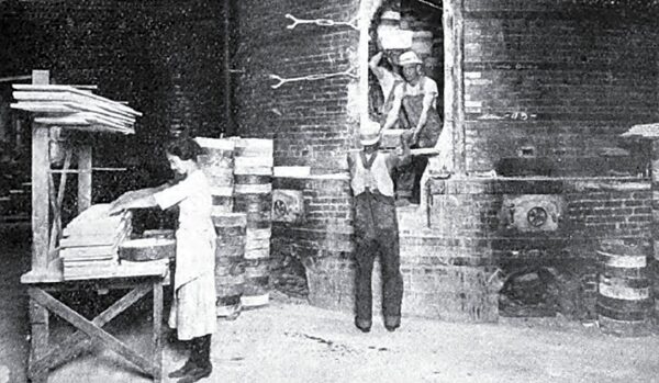 Loading the Kilns. Saggers, Fired to 2,600 Deg. F., Last Six Burns in This Plant. Note How They Are Used After Failure Begins.