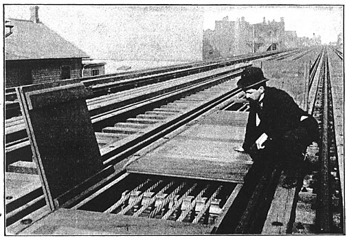 A. SECTION OF THE FINISHED FEEDER BOX SHOWING TWO OF THE TRAP DOORS OVER THE INSULATING SUPPORTS OPEN.